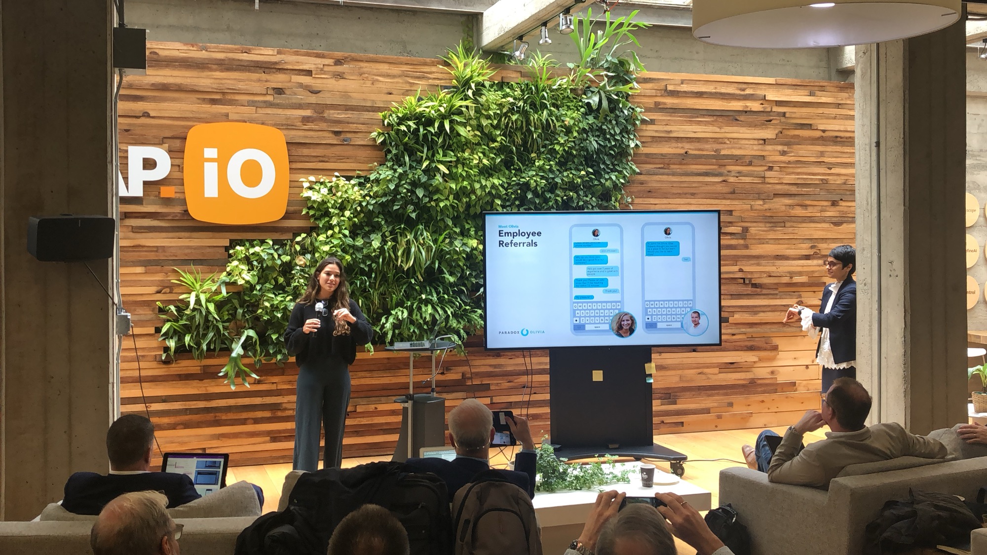 Presenting Olivia and Paradox's conversational AI on stage.