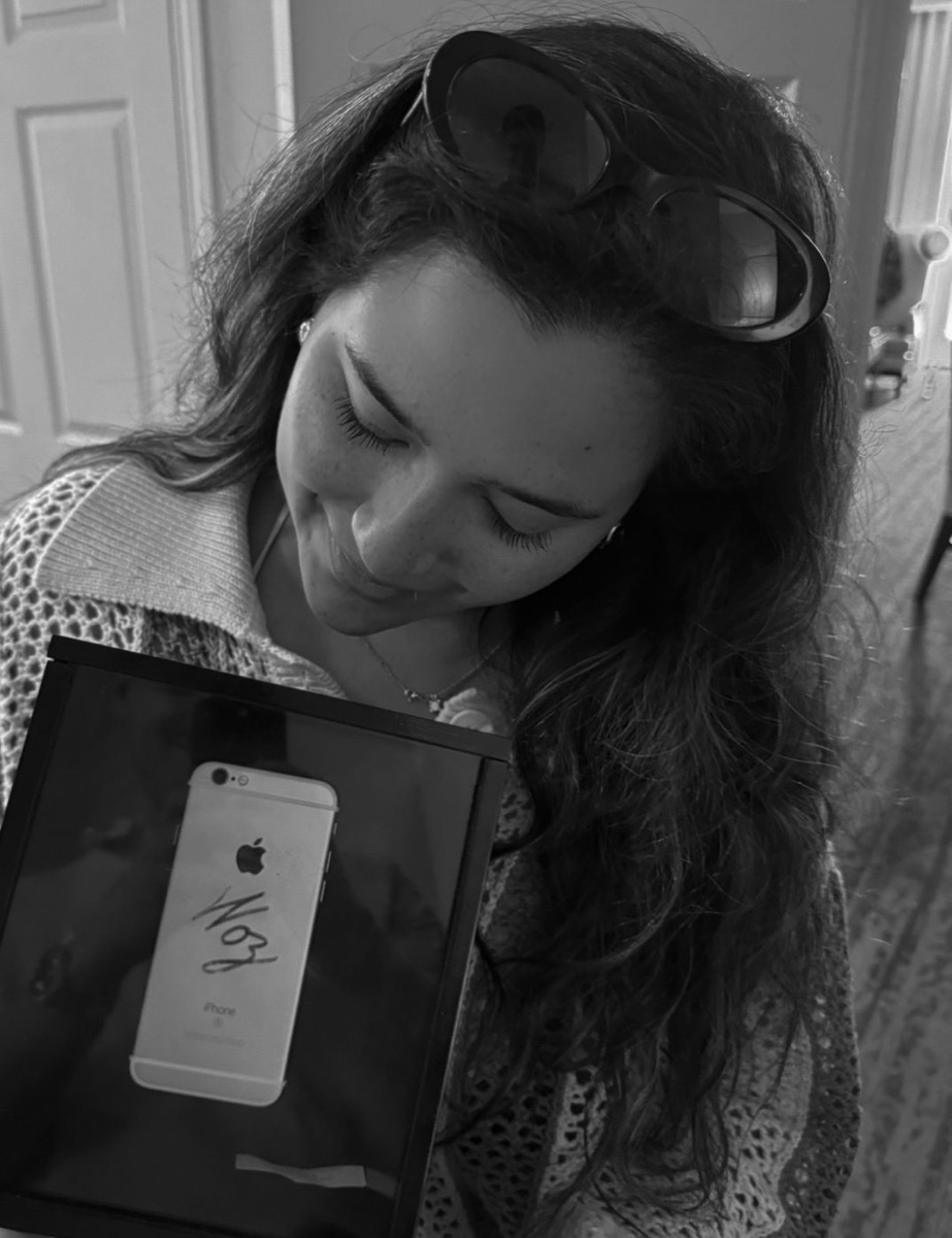 Holding my iPhone, signed by Apple co-founder Steve Wozniak